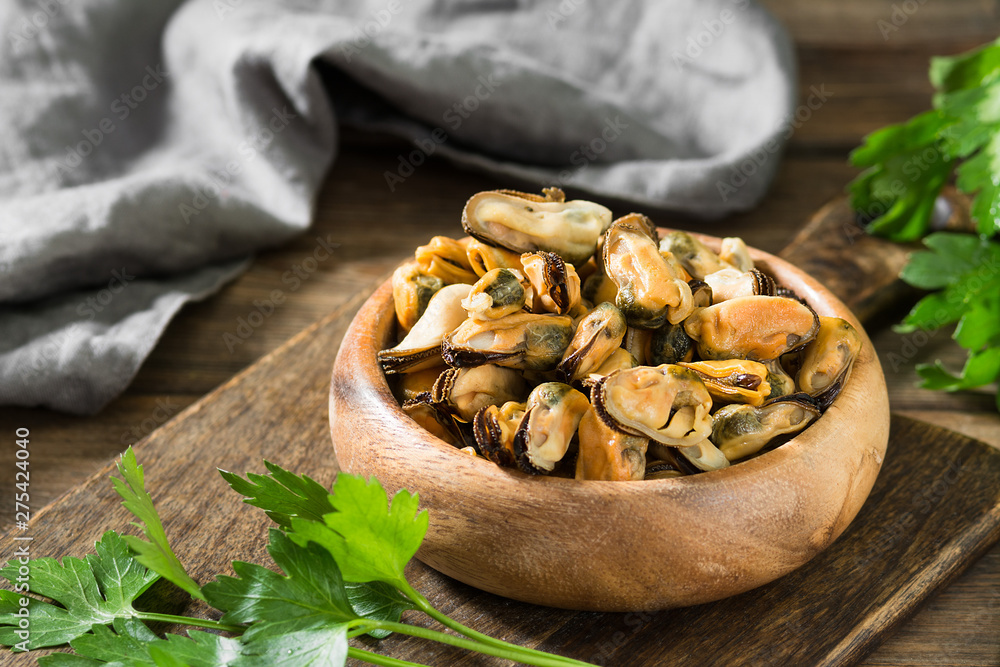 Mussel meat on a wooden Board on a wooden table. Rustic style Mussel meat on a wooden Board on a wooden table. Rustic style