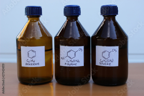 Organic solvents in dark glass bottles: benzene, p-xylene, toluene. photo
