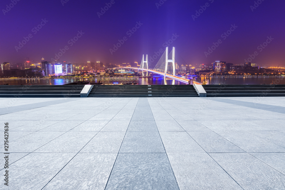 Empty square floor and bridge buildings at night in Shanghai,China