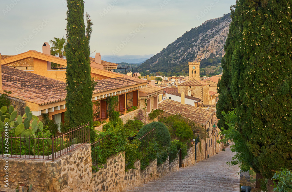 View At carrer del Calvari With Typical Old Houses And City Center Pollença, old village on the island Palma Mallorca, Spain