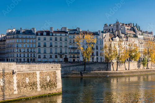 France, Paris, 4th arrondissement, île Saint Louis, buildings of the Quai d'Orleans on the bank of the Seine river and the tip of L'île de la Cite, seen from the Quai Montebello. photo