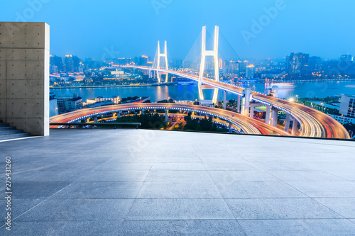 Empty square floor and bridge buildings at night in Shanghai China