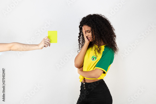 Picture  of a Brazil's National team young supporter receiving a yellow card