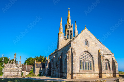 France, Brittany, Bay of Audierne, wayside cross and chapel of Notre-Dame-de-Tronoen (15th century) photo