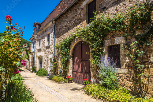 France, Dordogne, Perigord Vert, Saint-Jean-de-Cole (Plus Beau Village de France - Most Beautiful Village in France), peasant houses with flowers along the street photo