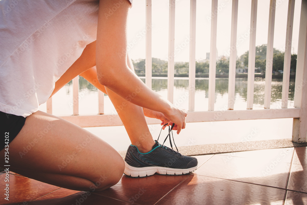 Healthy woman doing exercises and warm up before running and jogging on bridge at morning Healthy woman doing exercises and warm up before running and jogging on bridge at morning