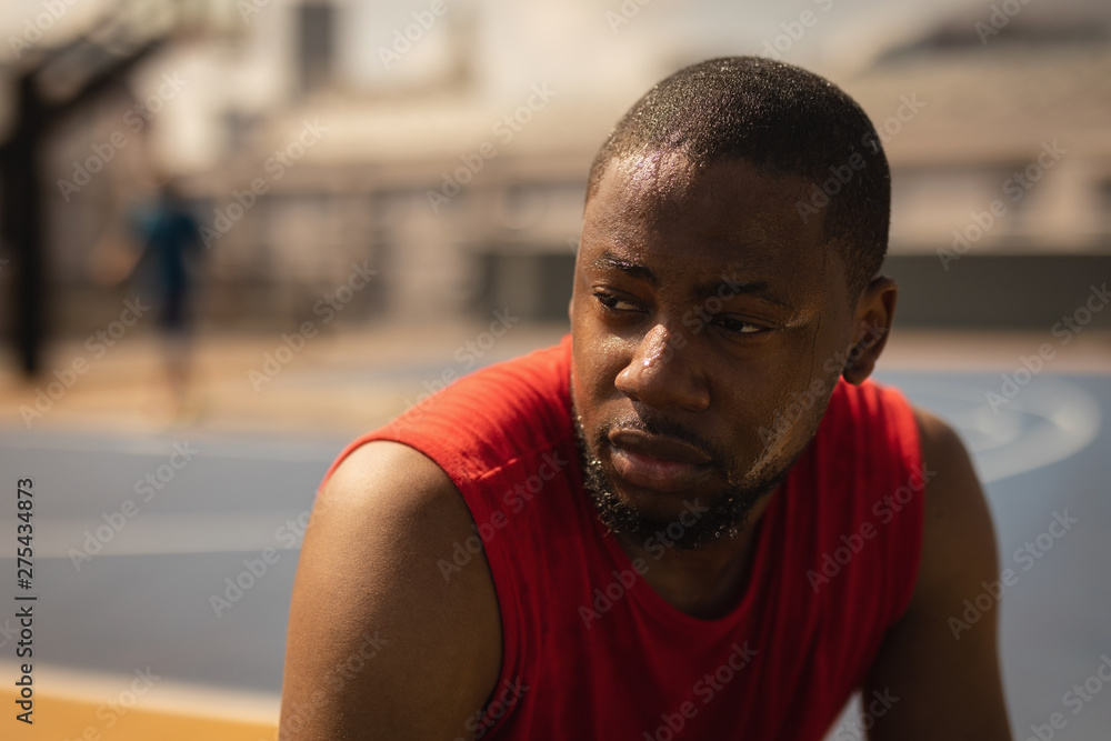Basketball player relaxing at basketball court Basketball player relaxing at basketball court