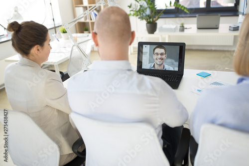 business, employment and technology concept - team of employers having video conference or job interview with new employee at office