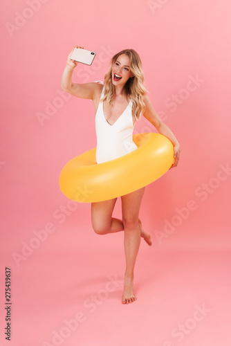 Happy pretty young girl wearing swimsuit standing