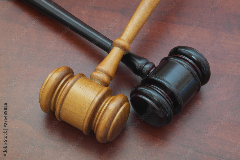 Different court decisions concept with two gavels on table Different court decisions concept with two gavels on table