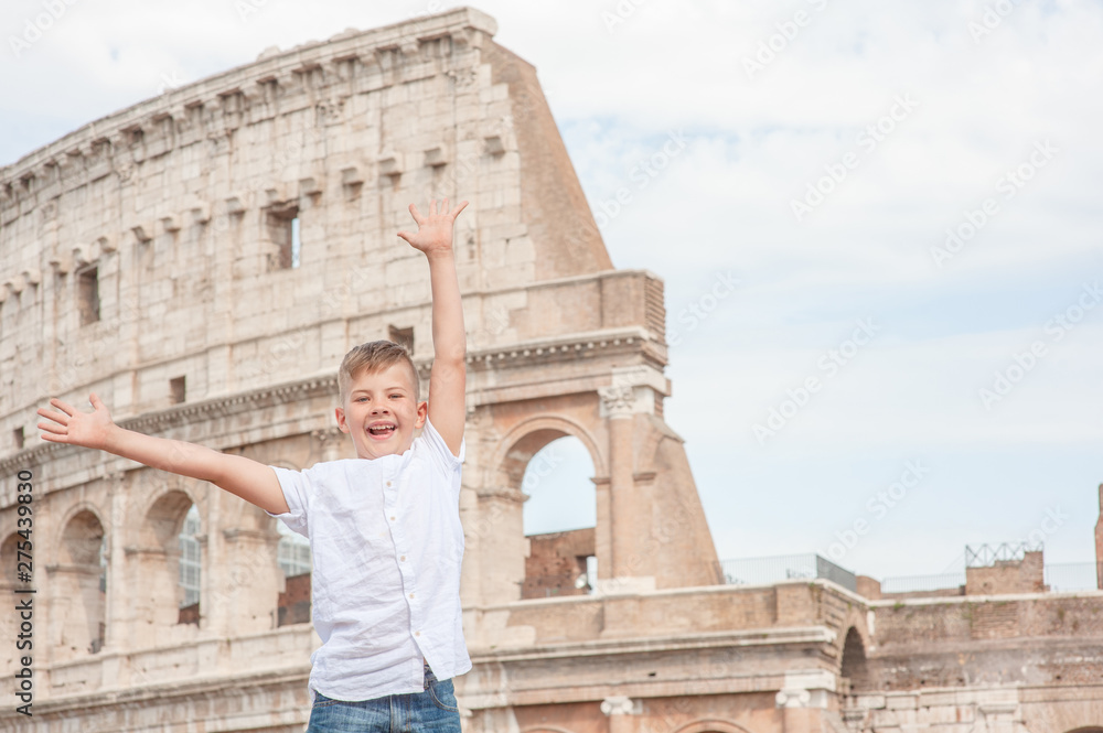 Very happy boy near coliseum in Rome, Italy. Travel concept. Space for text.