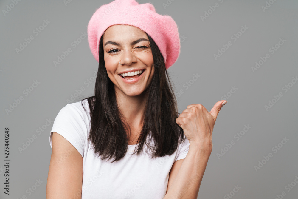 Attractive young brunette woman wearing beret standing Attractive young brunette woman wearing beret standing