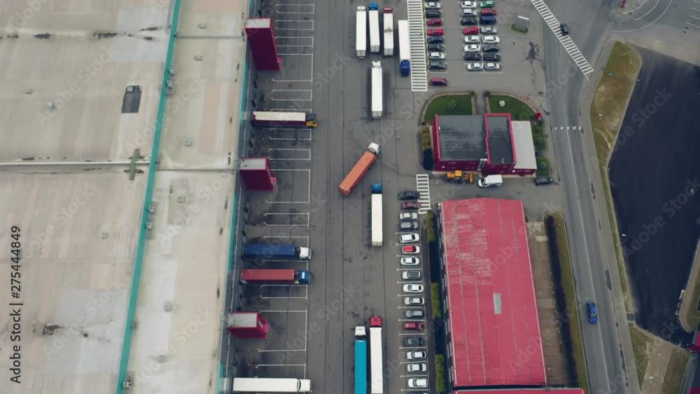 Aerial Shot of Industrial Warehouse Loading Dock where Many Truck with Semi Trailers Load Merchandise. Aerial Shot of Industrial Warehouse Loading Dock where Many Truck with Semi Trailers Load Merchandise.
