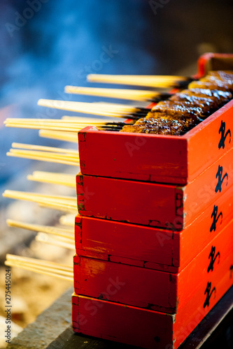 Fried tofu on bamboo sticks piled in red boxes, Iga ueno, Japan photo