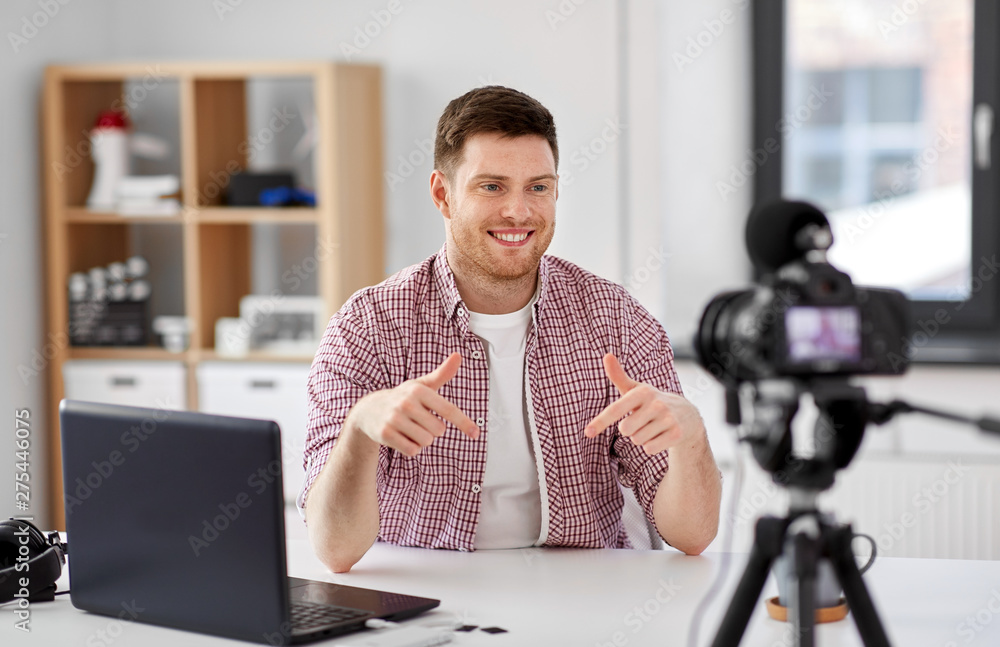 blogging, videoblog and people concept - male blogger with camera recording video at home office blogging, videoblog and people concept - male blogger with camera recording video at home office