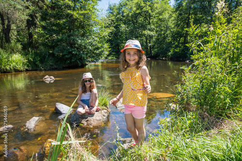 Auvergne - Rhone-Alpes - Haute-Loire - Saint-Julien-d'Ance - Girls playing on the bank of the Ance river. photo