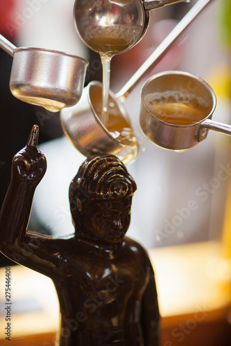 Worshippers celebrating hana matsuri on Buddha's birthday and for that spilling tea upon its statue, Senso ji, Tokyo, Japan