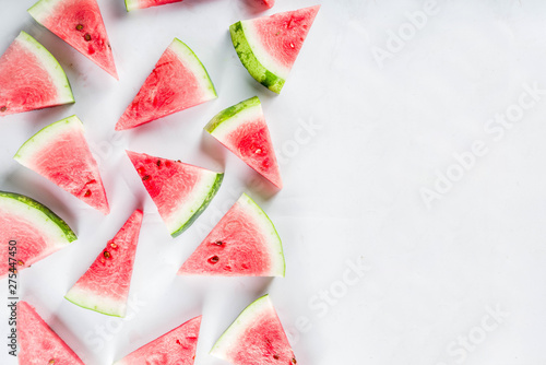Creative watermelon layout. Summer trendy bright pattern with sliced watermelon and tropical leaves, Above, flatlay with copy space
