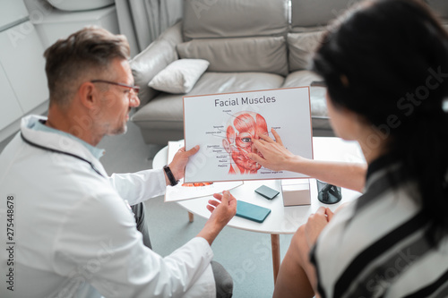 Woman asking questions about facial muscles before surgery photo