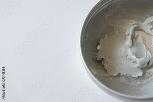 Macro natural deodorant cream in zero waste metal container on white background with copy space