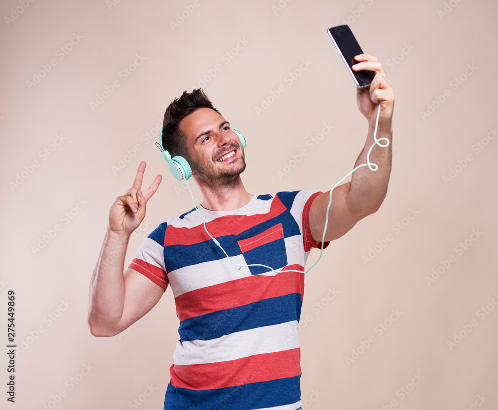 Young man making selfie in studio shot Young man making selfie in studio shot