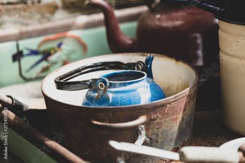 Blue teapot in rusty stewpan photo