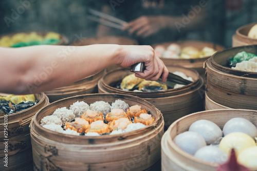 Photography buying tasty local specialty in vendor.
