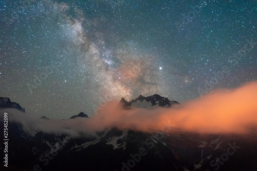 night sky with stars Milky Way over the mountains of the Caucasus with clouds