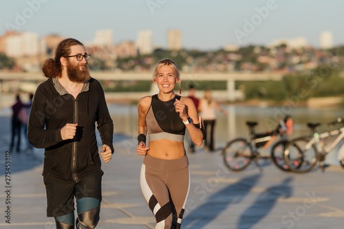 Happy married couple on morning jog outdoors in the city