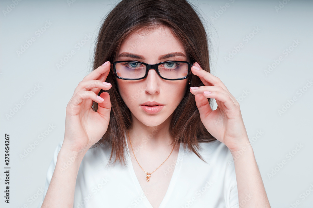 Close-up portrait of a girl with glasses on a white background Close-up portrait of a girl with glasses on a white background