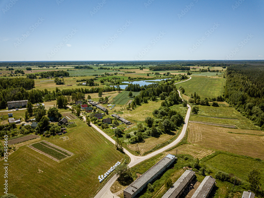 countryside roads and fields with small village. aerial view