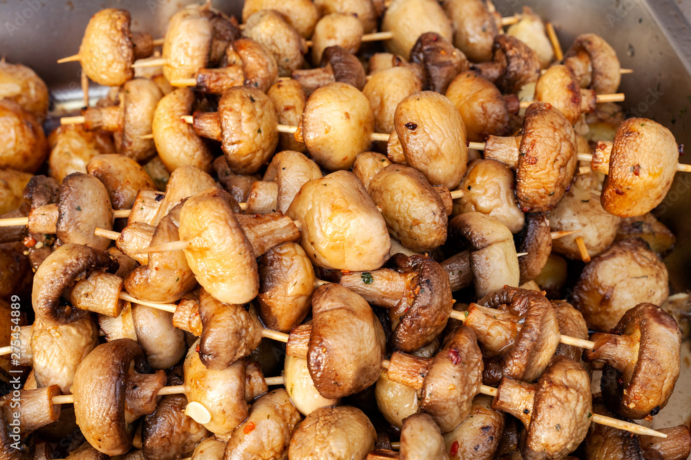 Grilled champignon mushrooms fried on fire Grilled champignon mushrooms fried on fire