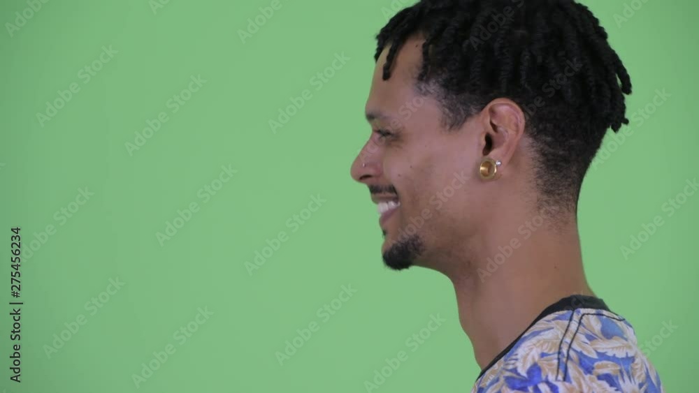 Closeup profile view of happy young African man being interviewed Closeup profile view of happy young African man being interviewed