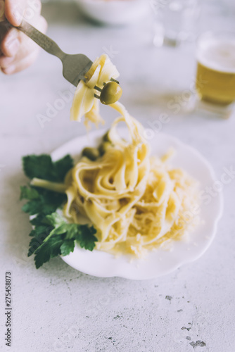 Fork taking pasta from a plate