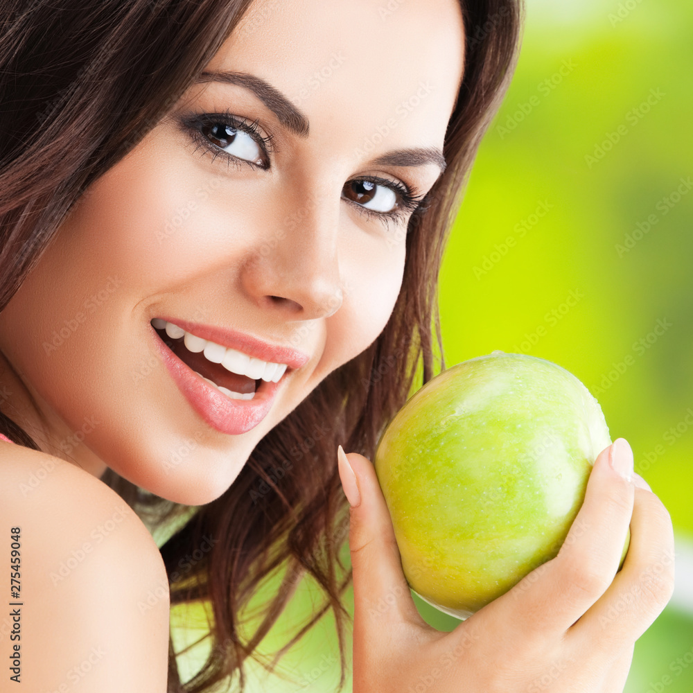 smiling dark haired girl with green apple smiling dark haired girl with green apple
