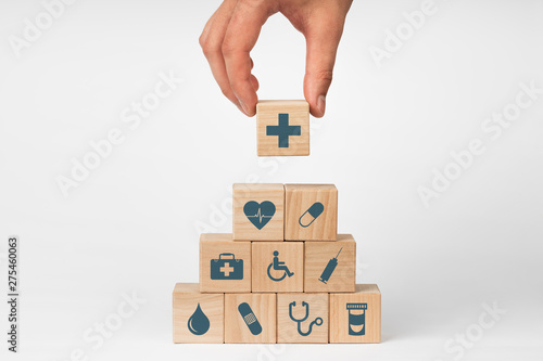 Concept of Insurance for your health, Hand hold wooden block with icon healthcare medical