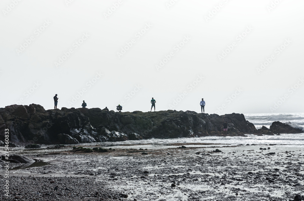 Africa, Morocco, the silhouettes of photographers who are standing on a rock and taking pictures of the sunset, there is space for advertising
