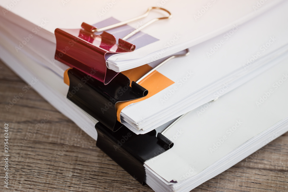 Stacks of piles unfinished papers documents files in accounting business report with black clips paper corner on desk in busy office, Paperwork of financial folder at business workplace concept Stacks of piles unfinished papers documents files in accounting business report with black clips paper corner on desk in busy office, Paperwork of financial folder at business workplace concept