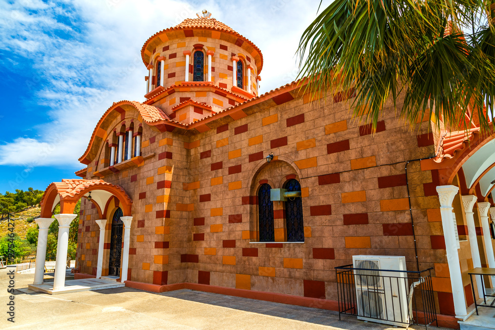 A view of church red brick against the sky with clouds on Greek island, Greece