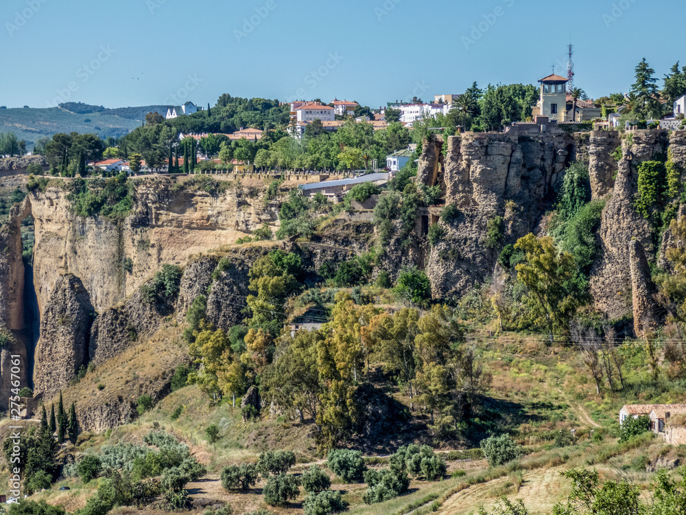 Ronda, Spain: Landscape of white houses on the green edges of steep cliffs.