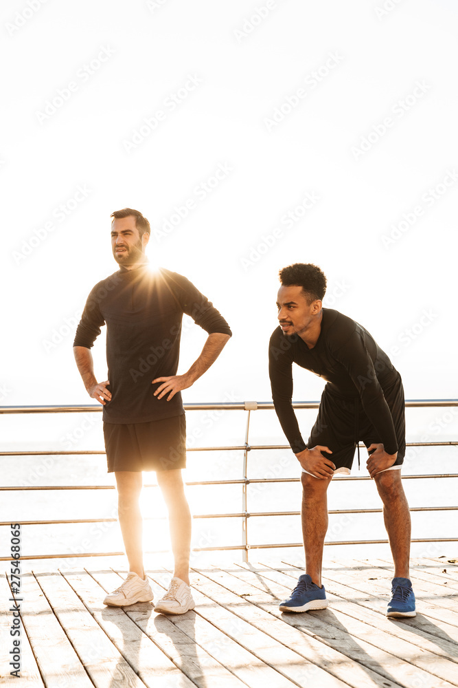 Two attractive young healthy sportsmen outdoors Two attractive young healthy sportsmen outdoors