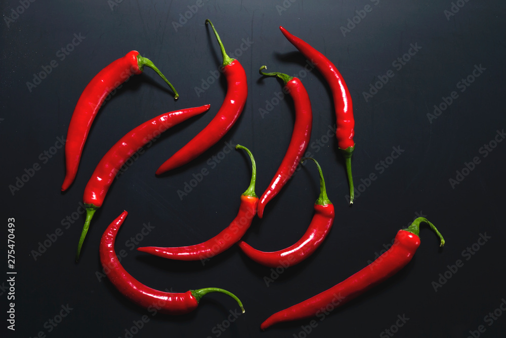 Spicy red chilli peppers on a black background Spicy red chilli peppers on a black background