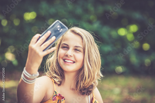 girl with smartphone outdoors photo