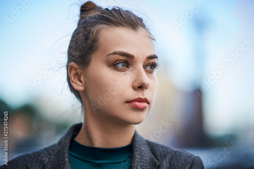 portrait of a serious, young woman in the city
