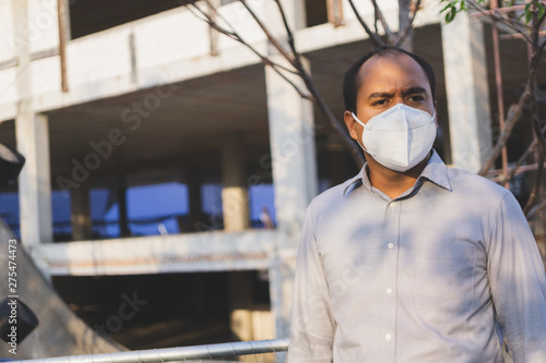 Man wearing facial hygienic mask nose outdoors. Air pollution concept.