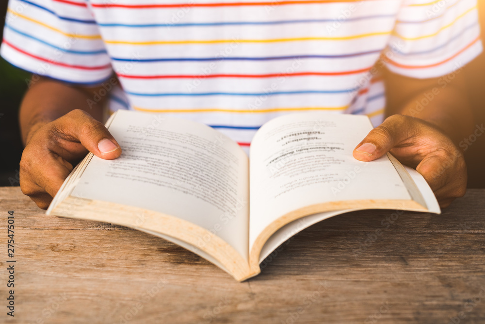 Young asian man reading book. Young asian man reading book.