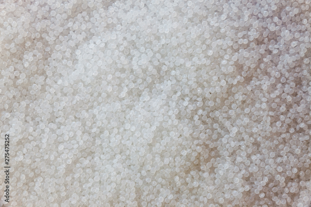 Close-up of plastic polymer granules. hand hold Polymer pellets. polymer plastic. compound polymer. Close-up of plastic polymer granules. hand hold Polymer pellets. polymer plastic. compound polymer.