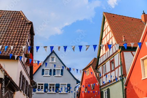 Oktoberfest decoration in the streets of old German town. Street with traditional Houses and Oktoberfest garland photo