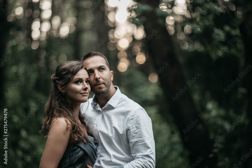 Loving couple in the woods on a romantic date at engagement. The young family is happy in harmony. Loving couple in the woods on a romantic date at engagement. The young family is happy in harmony.