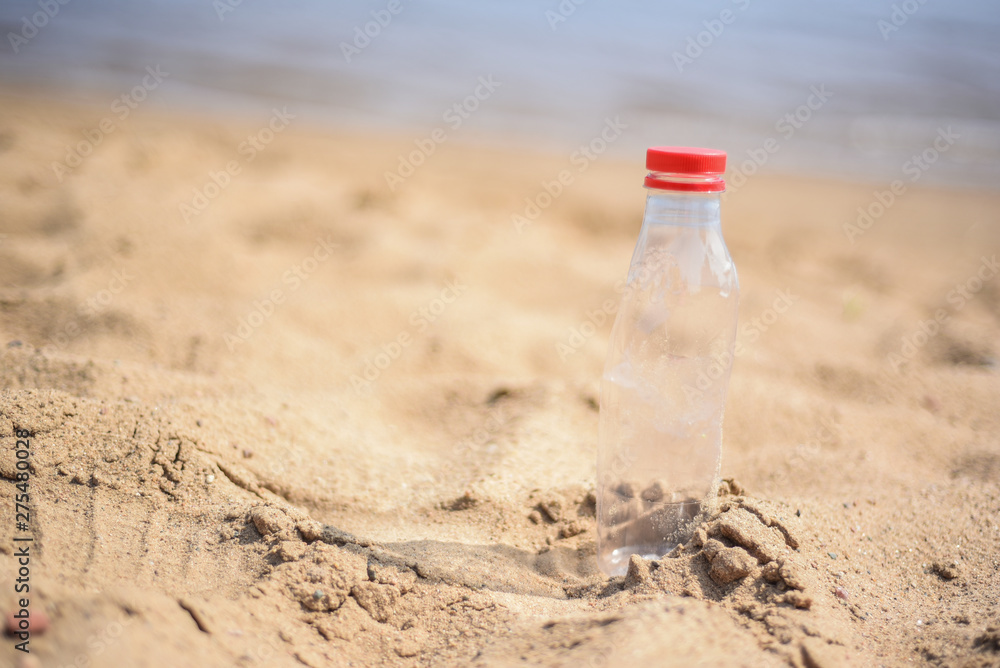 Reduce the use of plastic bottles reuse,recycling the Empty used plastic bottle.A discarded plastic bottle is washed up on a sandy beach.Ecology,earth protection,nature conservation,pollution sea. Reduce the use of plastic bottles reuse,recycling the Empty used plastic bottle.A discarded plastic bottle is washed up on a sandy beach.Ecology,earth protection,nature conservation,pollution sea.